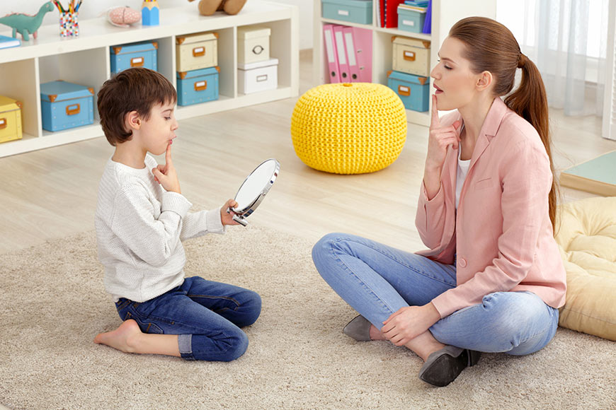 Photo of a little boy doing speech therapy with therapist