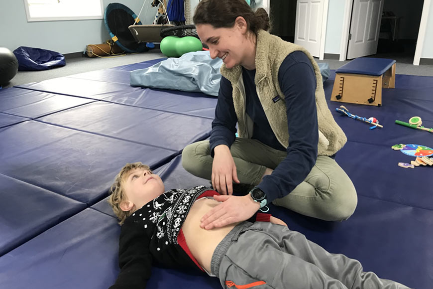 Photo Of A Young Boy Doing Physical Therapy With Therapist