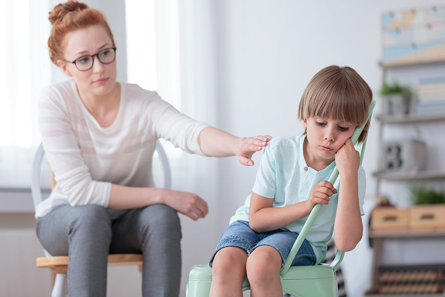Photo of a little boy resisting therapy with therapist