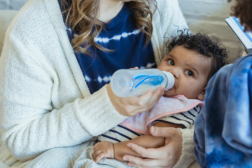 Photo of a woman bottle feeding a baby