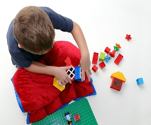 Photo of a little boy playing with Legos