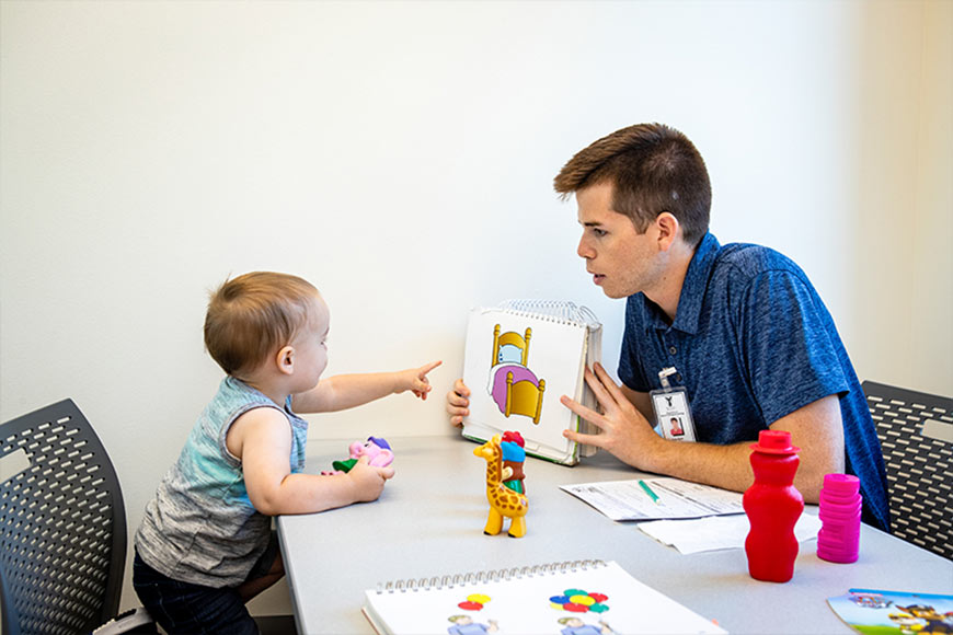 Photo Of A Little Boy Doing Speech Therapy With Therapist