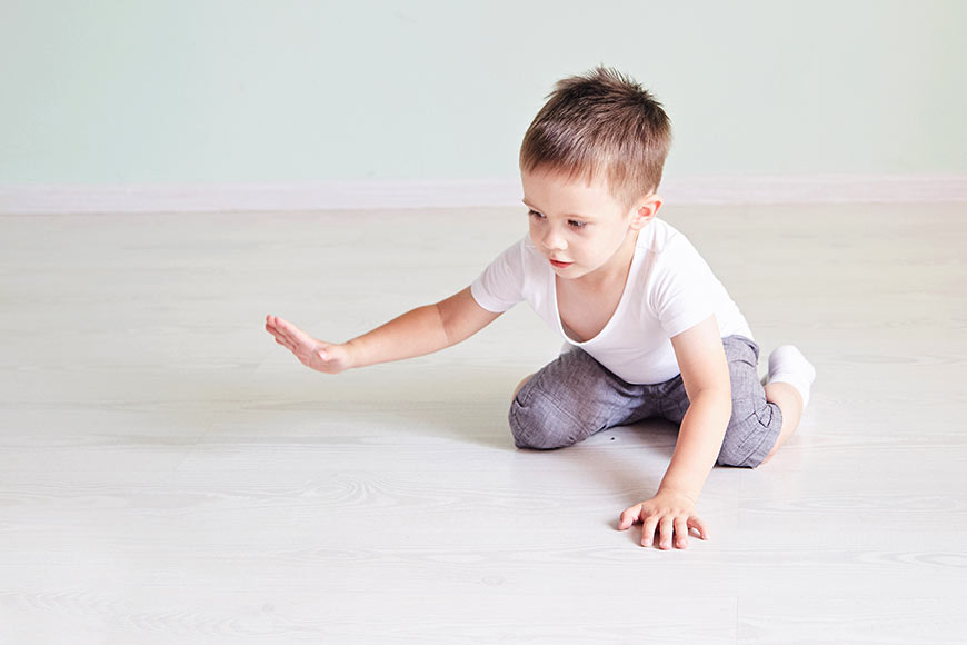 Photo of a little boy crawling on the floor