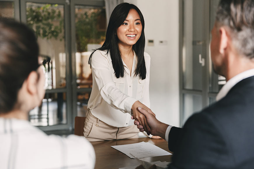 Photo Of A Woman At An Interview Shaking Hands With Potential Employer