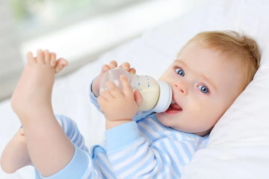 Photo of a baby drinking a bottle