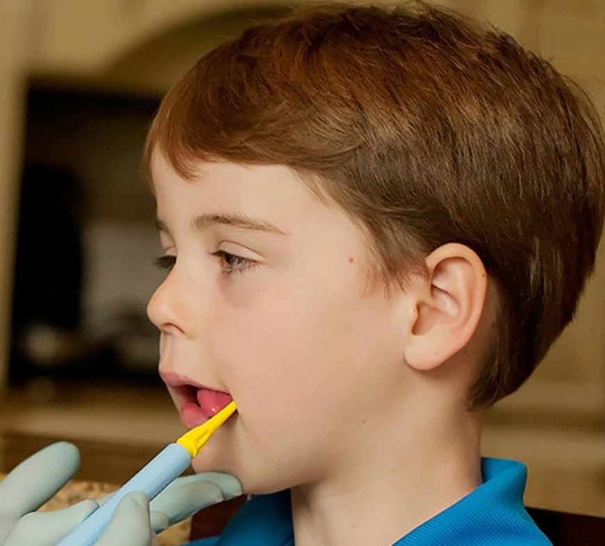 Photo of a little boy getting an oral motor exam