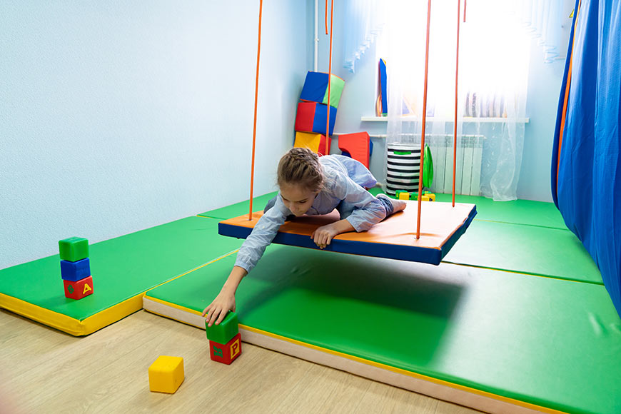 Photo Of A Little Girl Playing With Blocks On A Suspended Platform For Classes On Sensory Integration, Correctional, And Developmental Therapy